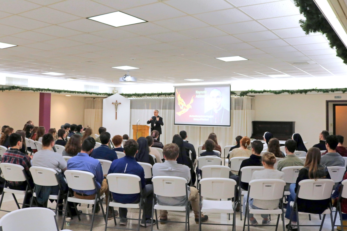 Teens and young adults listen to a keynote address by Bishop James Ruggieri.