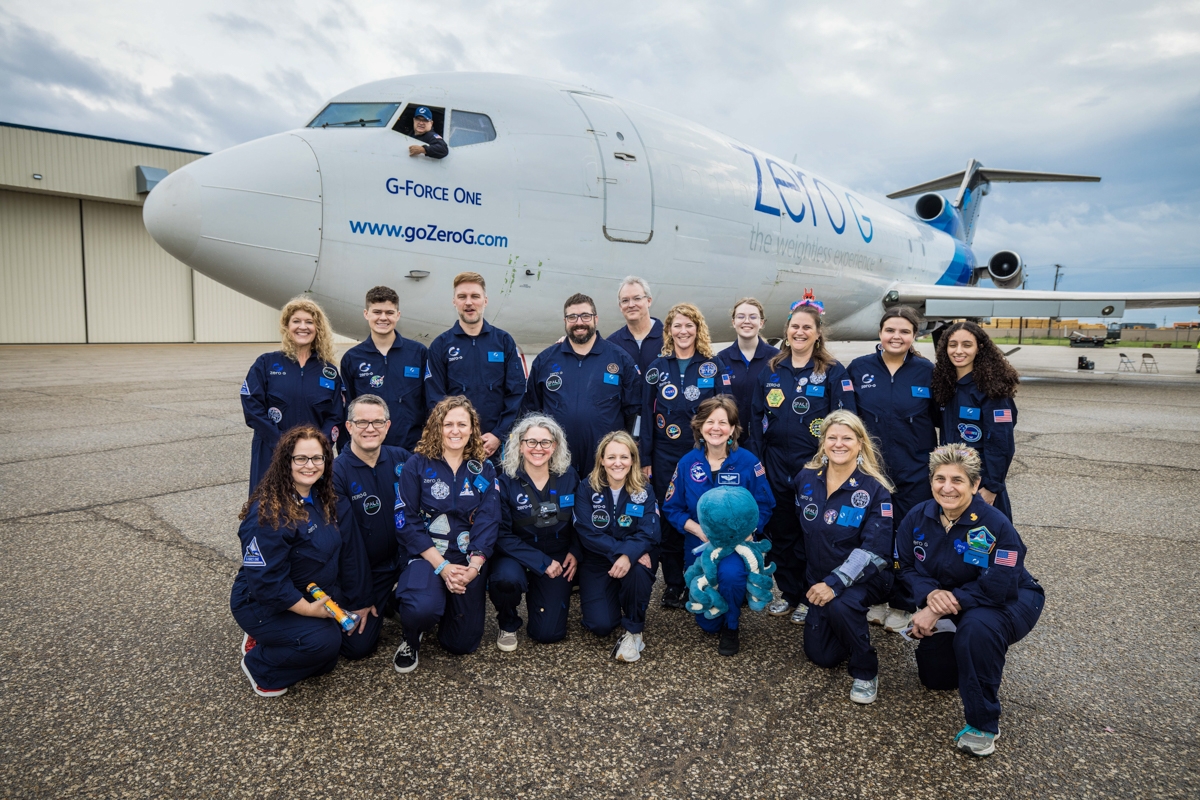 Pictured in front of G-Force One are the 8 teachers in the Embedded Teacher Program, with Space for Teachers mentors, NASA STEM Enhancement in Earth Science (SEES) interns, Zero-G pilot, Marcos Valdez, and Astronaut Cady Coleman