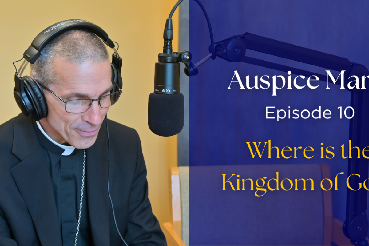 Bishop Ruggieri sitting in front of a microphone. text: "Auspice Maria, Episode 10: Where is the Kingdom of God?"