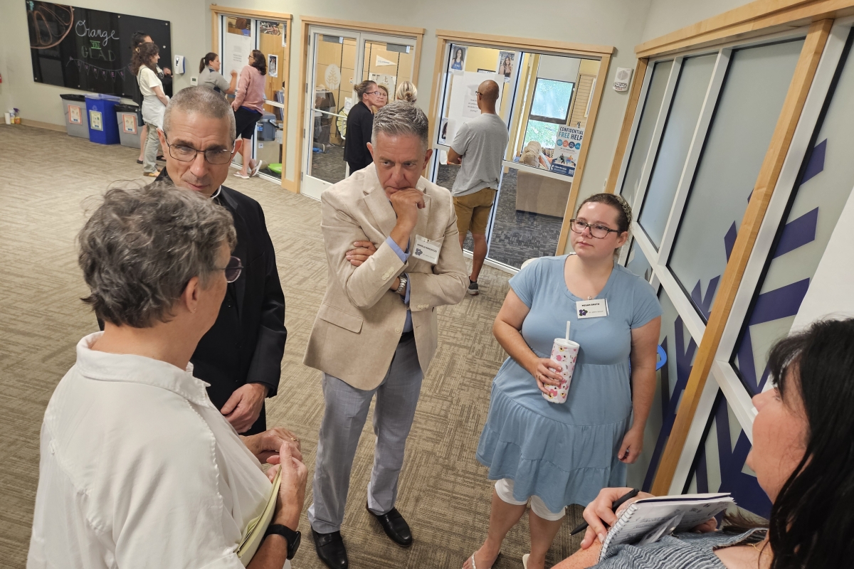 bishop speaking to a small group