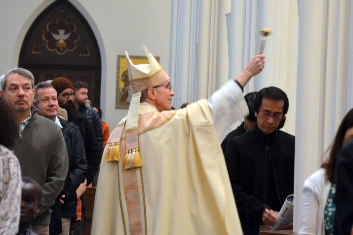 Bishop Ruggieri sprinkles the congregation with holy water.